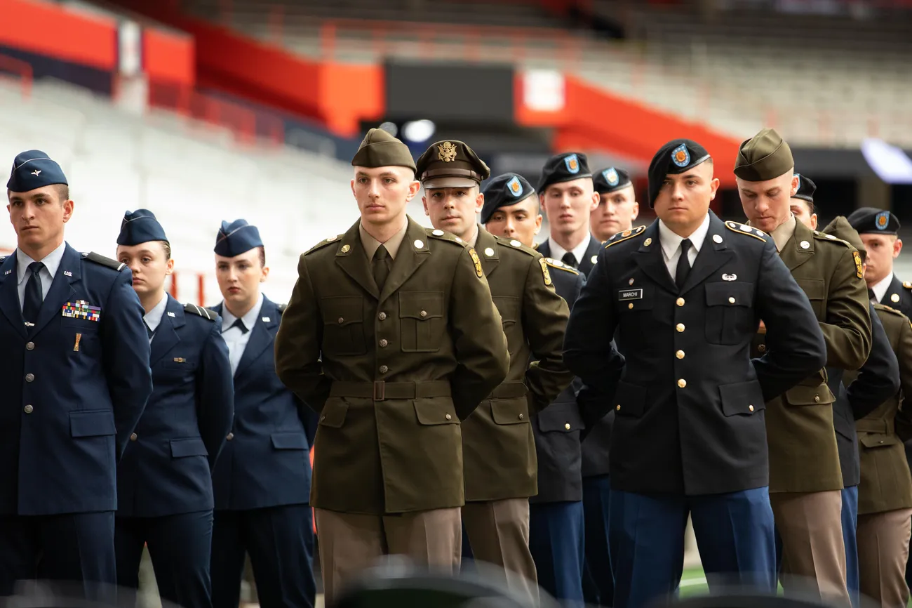 Army ROTC students and Air Force standing at attention wearing blue uniform at Chancellors Annual Review.