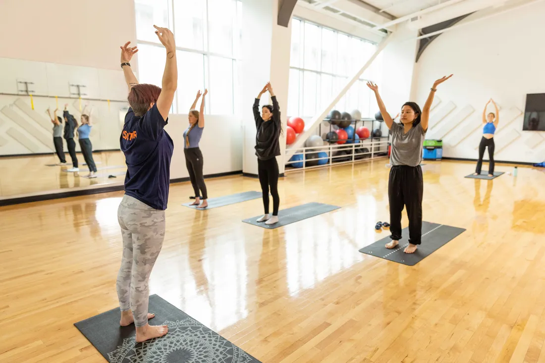 Students exercising during a group fitness class at the Barnes Center at The Arch.