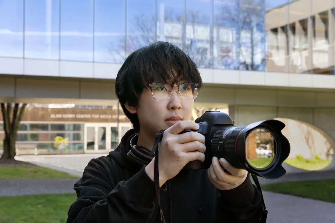 Joe Zhao taking a photo with his camera.