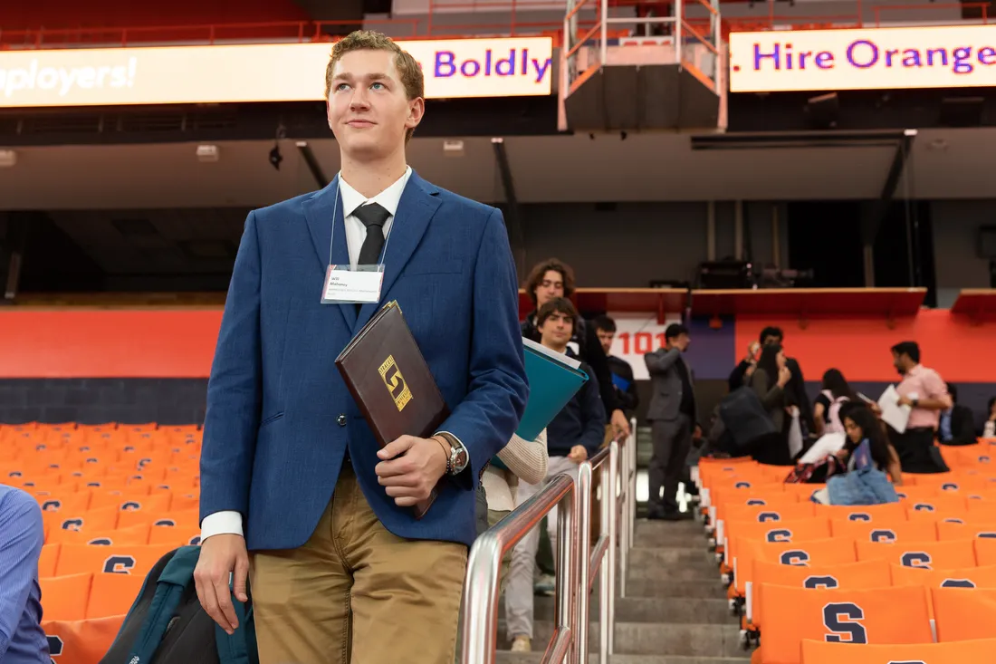 Will Mahaney walking down the stadium stairs to the career fair.
