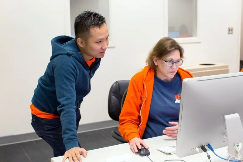 Two people working together on computer at Syracuse University, College of Engineering and Computer Science.