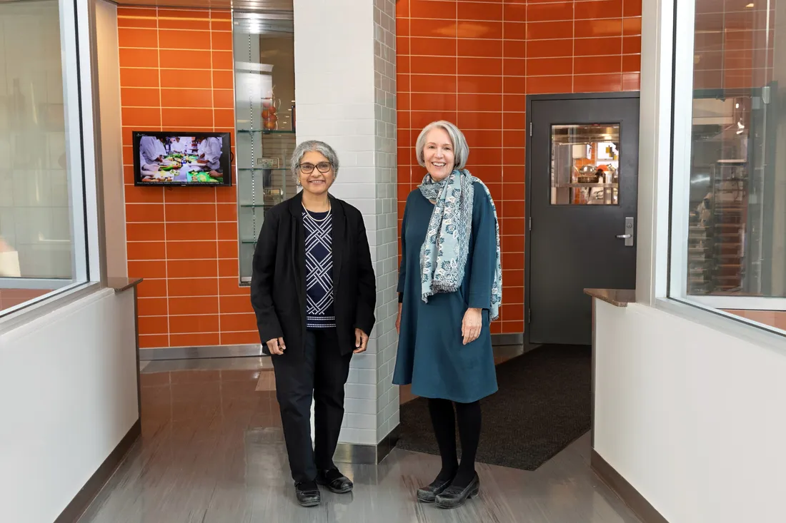 Sudha Raj and Kay S Bruening standing next to one another in Falk.