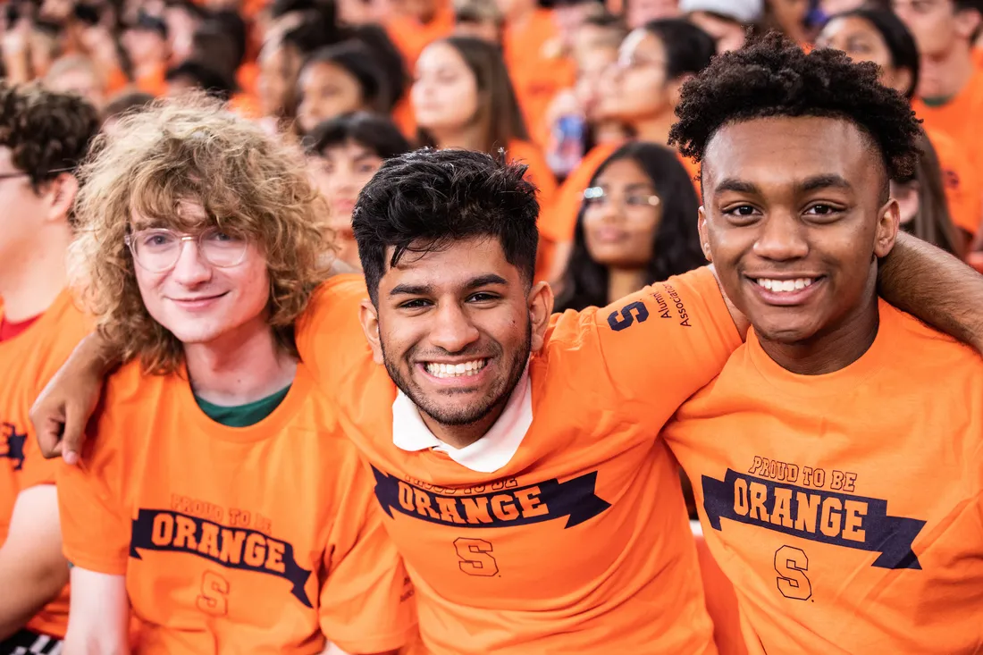 Three students in the Dome smiling at the camera