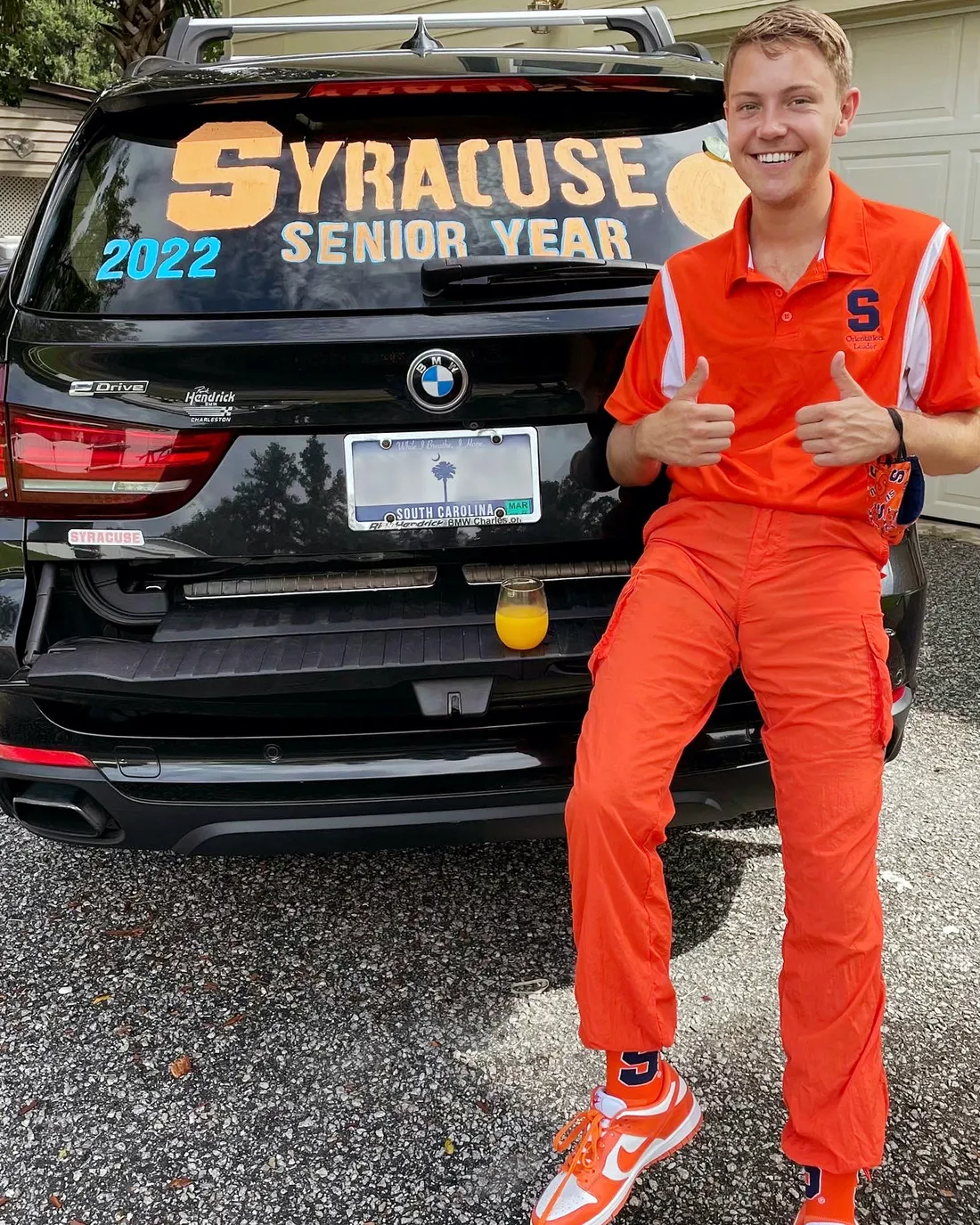 Daniel Wood poses in front of his car before leaving for his senior year at Syracuse