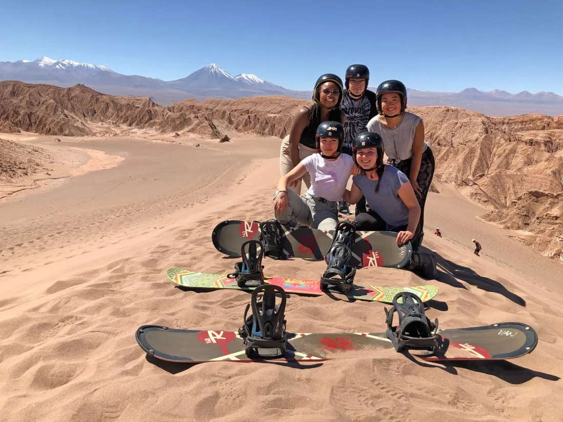 Cafui Awasu and friends from the Syracuse Santiago program sandboarding in the Atacama Desert in Chile.