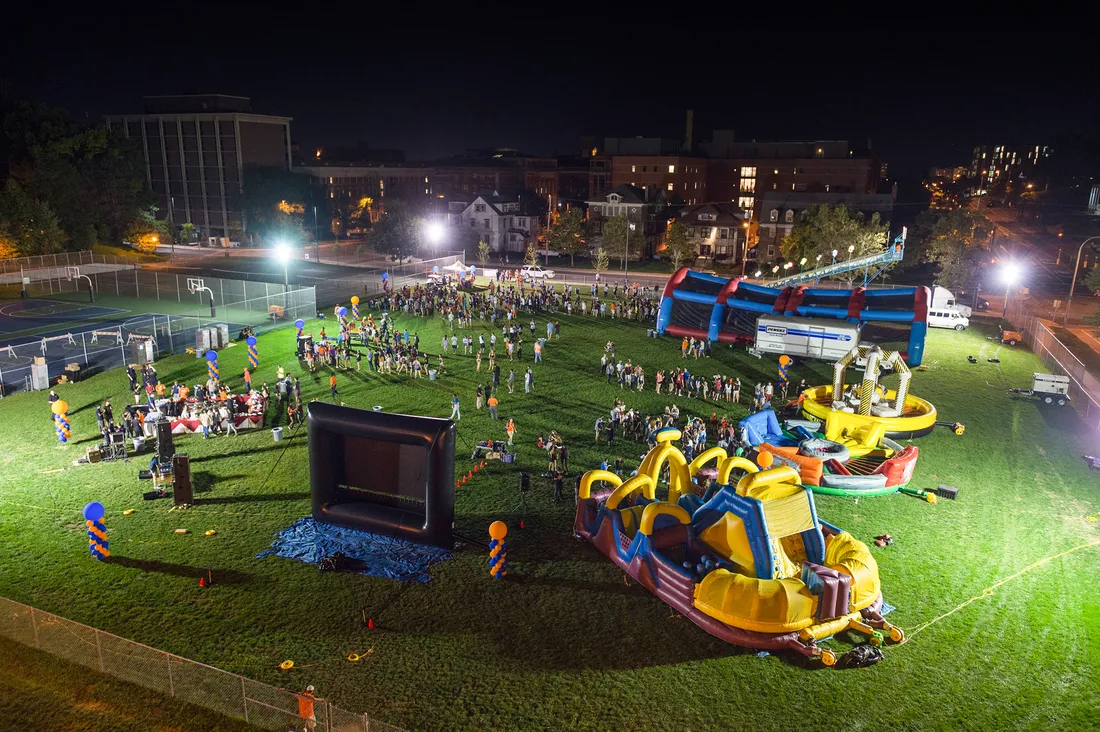 Aerial view of carnival-style event on sports field at night