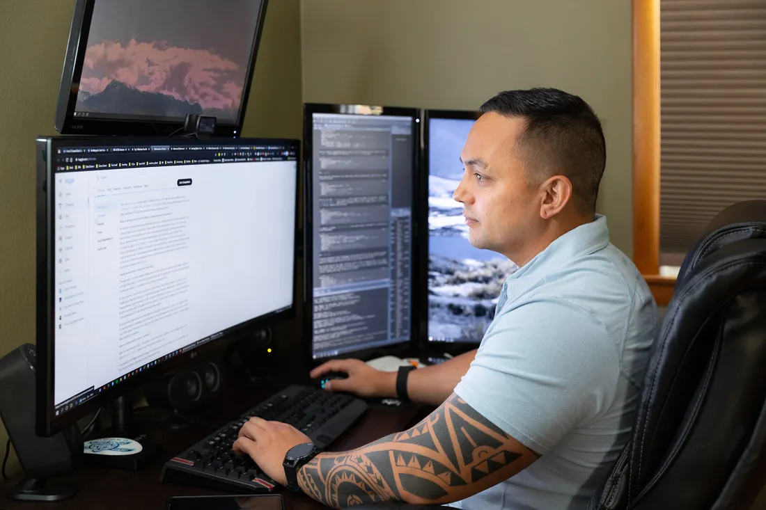 Person sitting at a desk taking an online course from a computer at home.