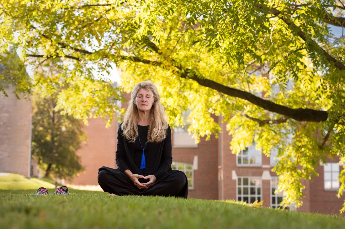 Public health professor Dessa Bergen-Cico ’86, G’88, G’92 meditating outside.
