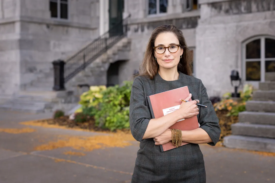 Dana Spiotta holds book in arms in front of the Hall of Languages.