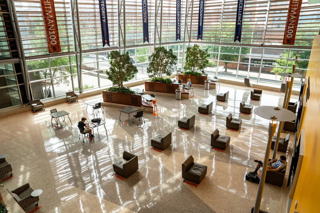 Tables in an atrium full of windows.