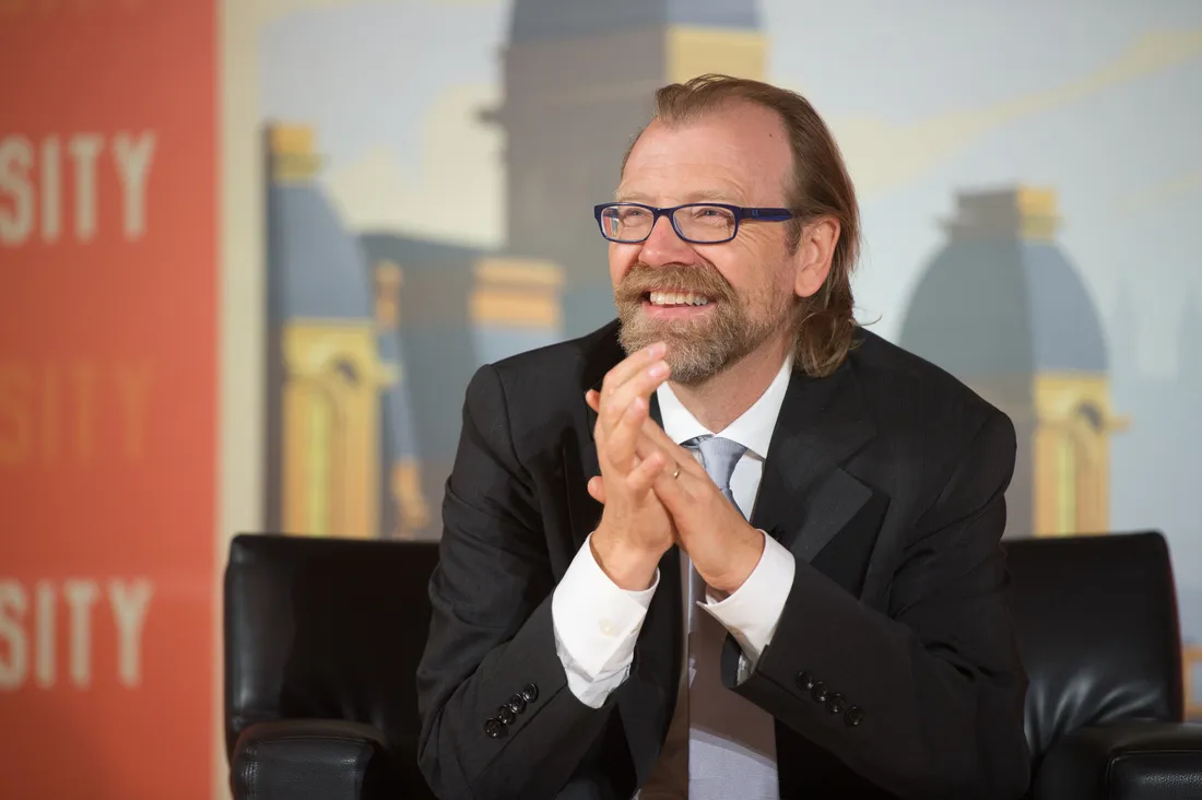 George Saunders sitting and smiling.
