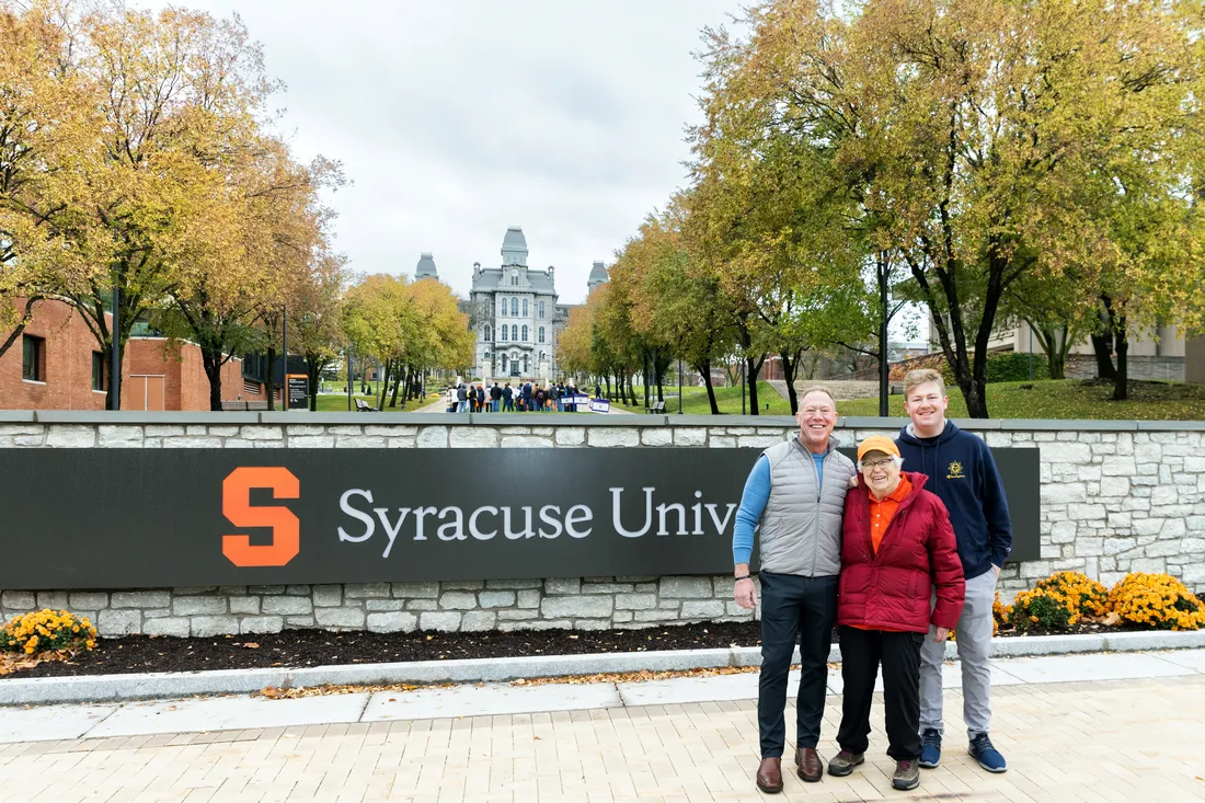 Jane Perrin ’52 and her son and grandson standing outside Syracuse University.