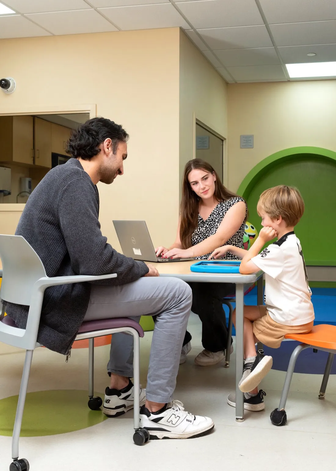 Gabby Garcia ’27 sitting with a child and their parent at the Golisano Center for Special Needs.