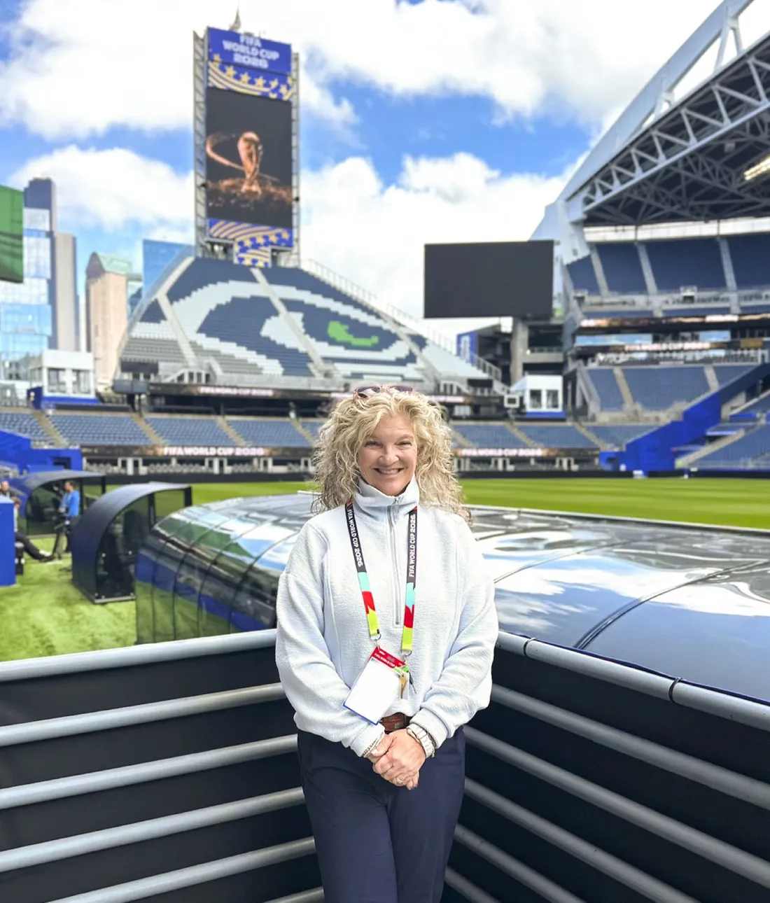 Alumna Melissa Tremel standing at a soccer stadium.