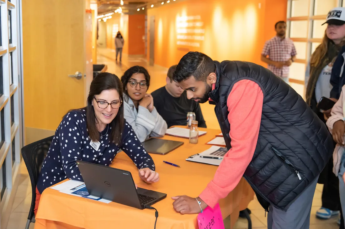 People standing around a computer.