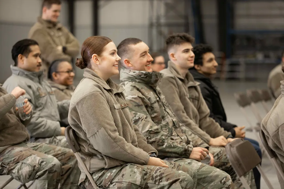 ROTC students siting and smiling.