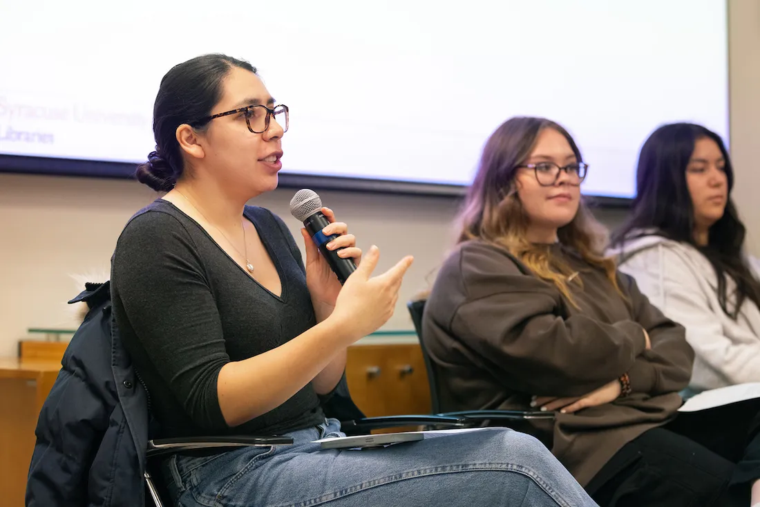 Three people speaking during a panel discussion.
