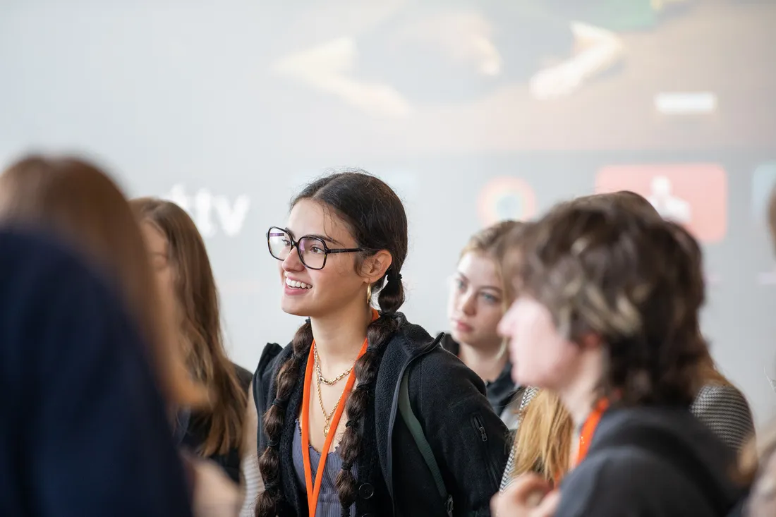 Portrait of a student listening intently to a presentation.