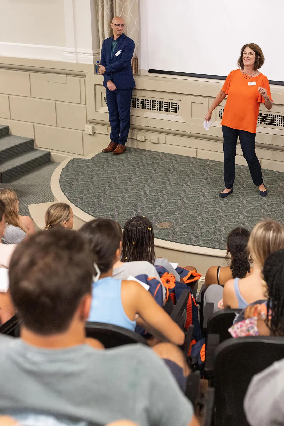 School of Education dean Kelly Chandler-Olcott stands in front of class in lecture hall.