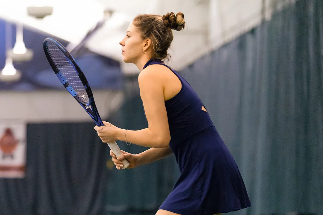 Student playing tennis.