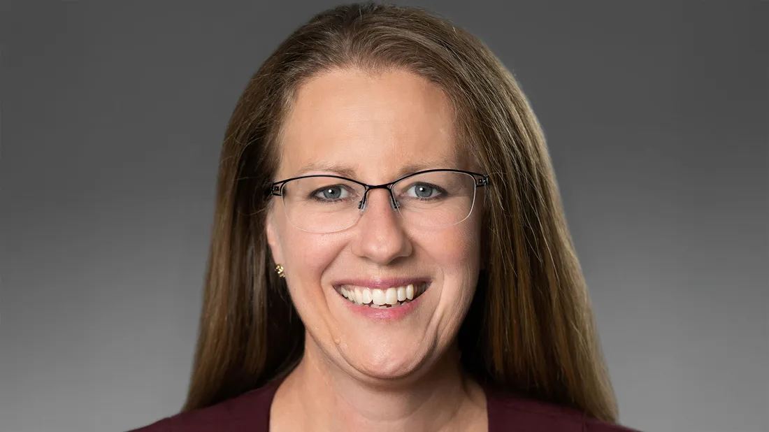 Heather Gaines smiling with glasses on.