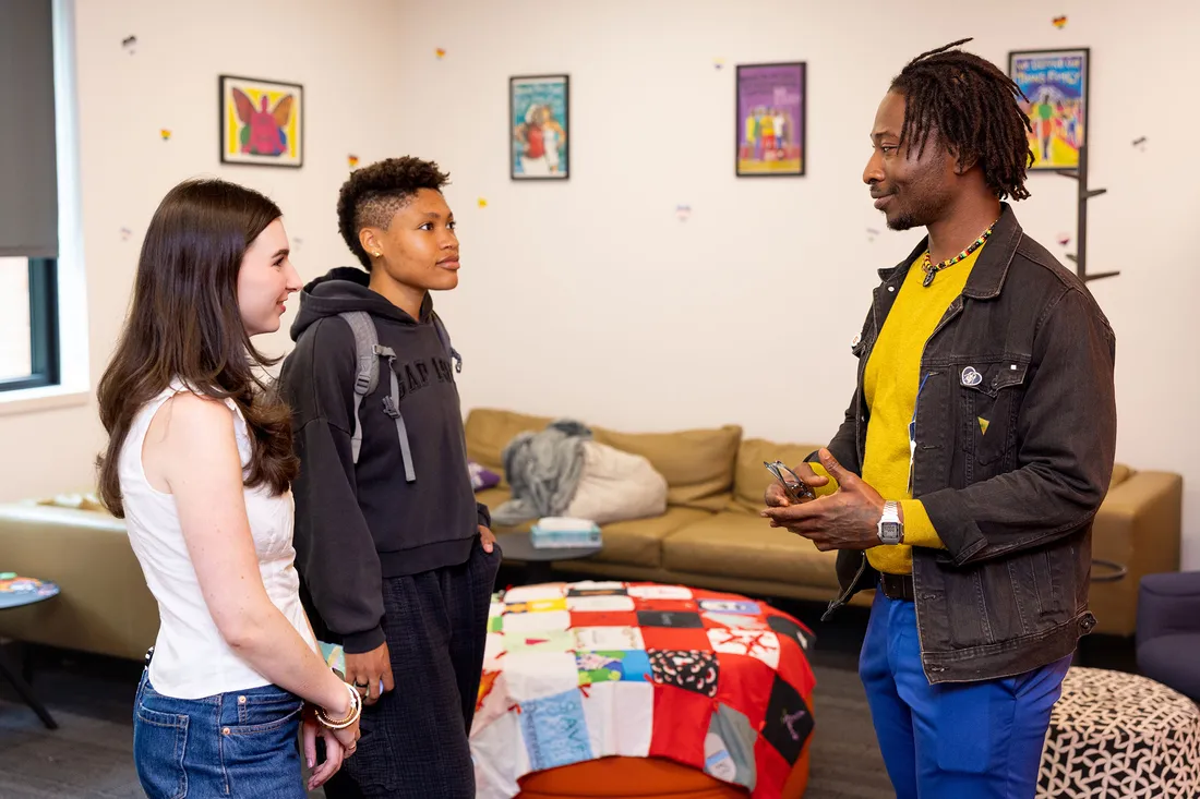 Alumni talking to students at a campus.