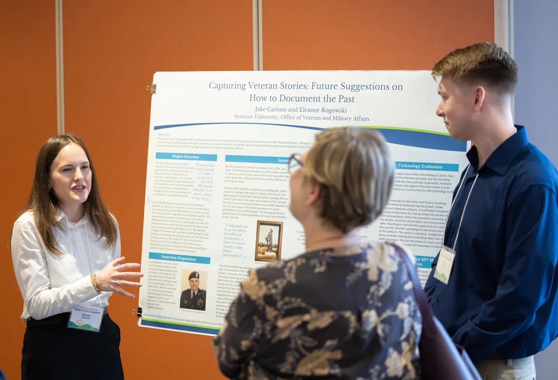 Two ROTC students present their research findings at a poster session.