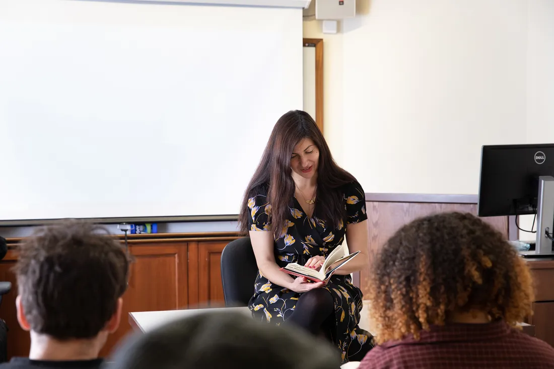 Mona Awad reading to a class.