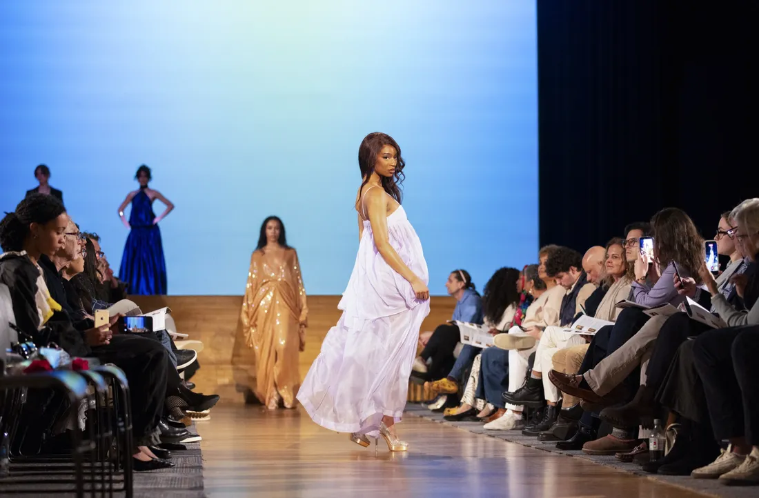 Students sitting and watching a fashion show.