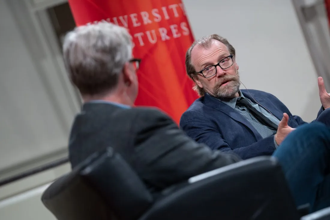 Professor George Saunders sitting in a chair speaking