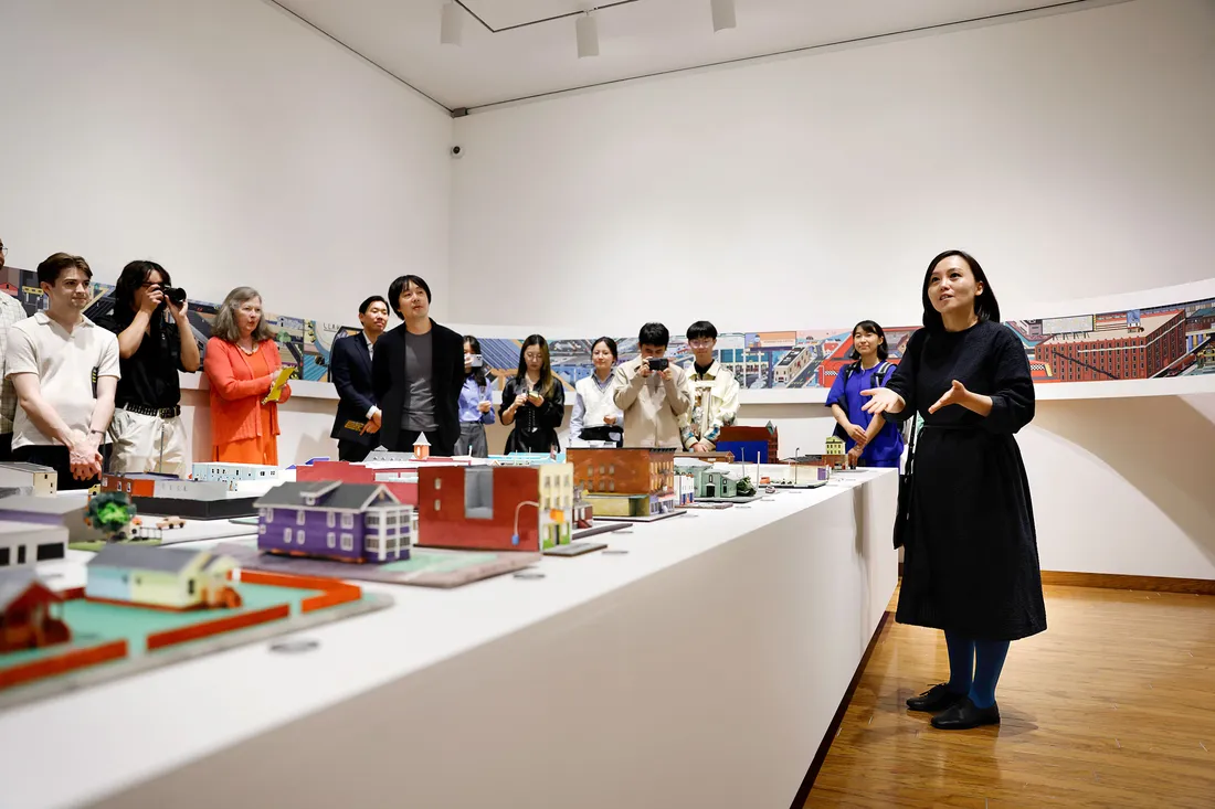 Woman speaking at art museum.