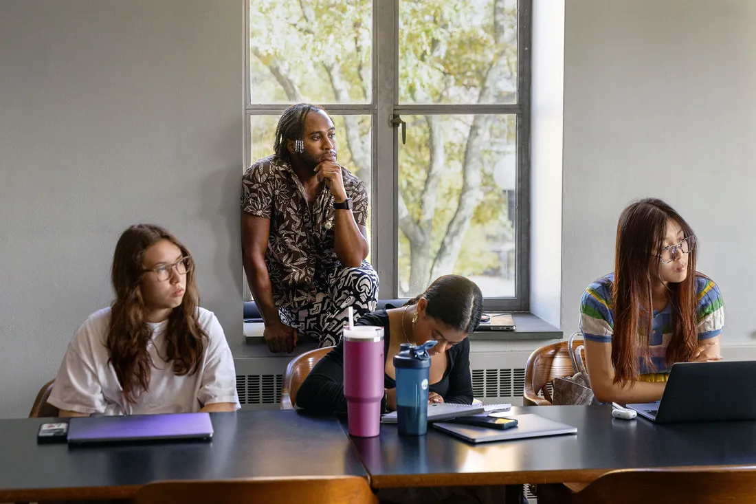 Students and teachers listening in classroom.