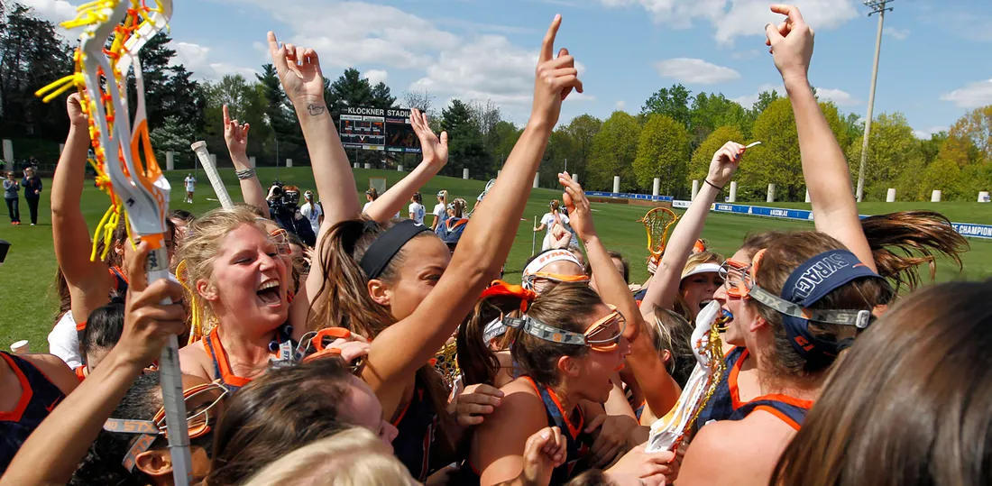 group of the women's lacrosse team celebrates.