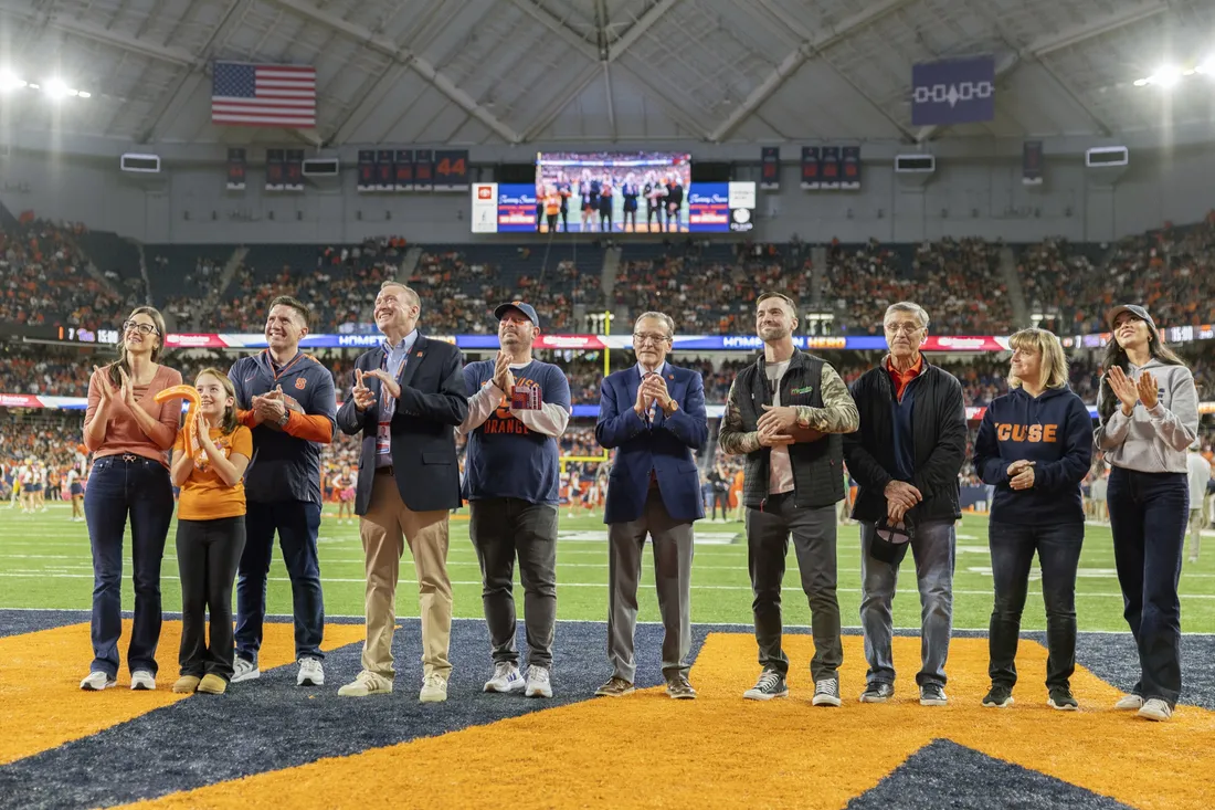 People standing on the field in the JMA Wireless Dome.