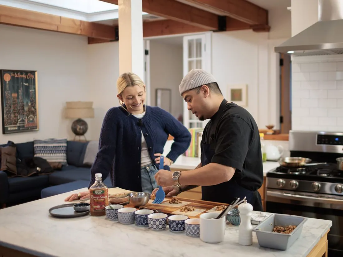 A boat on the ocean approaching a hump back whale.
