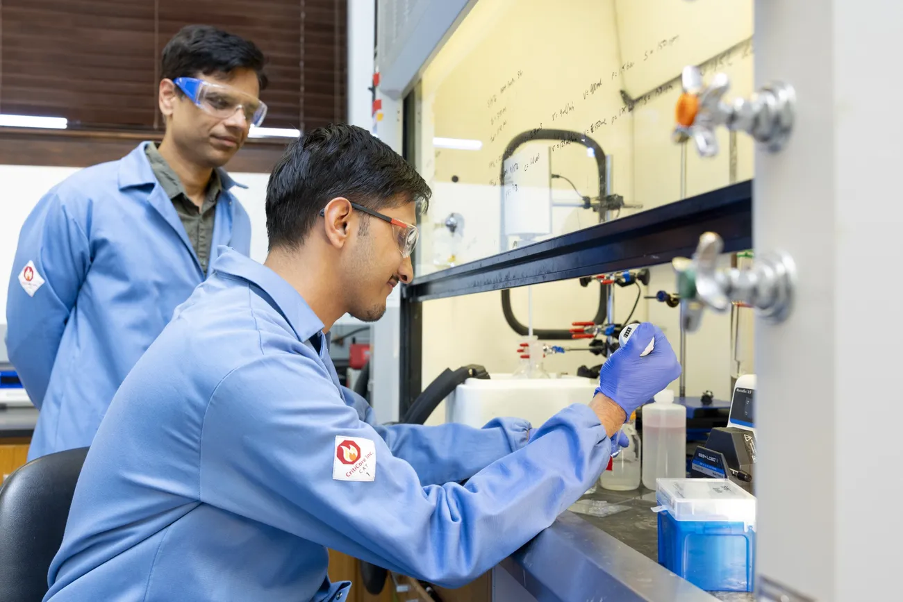 Pranav Soman and doctorate student Sharad Timilsina working in a laboratory.