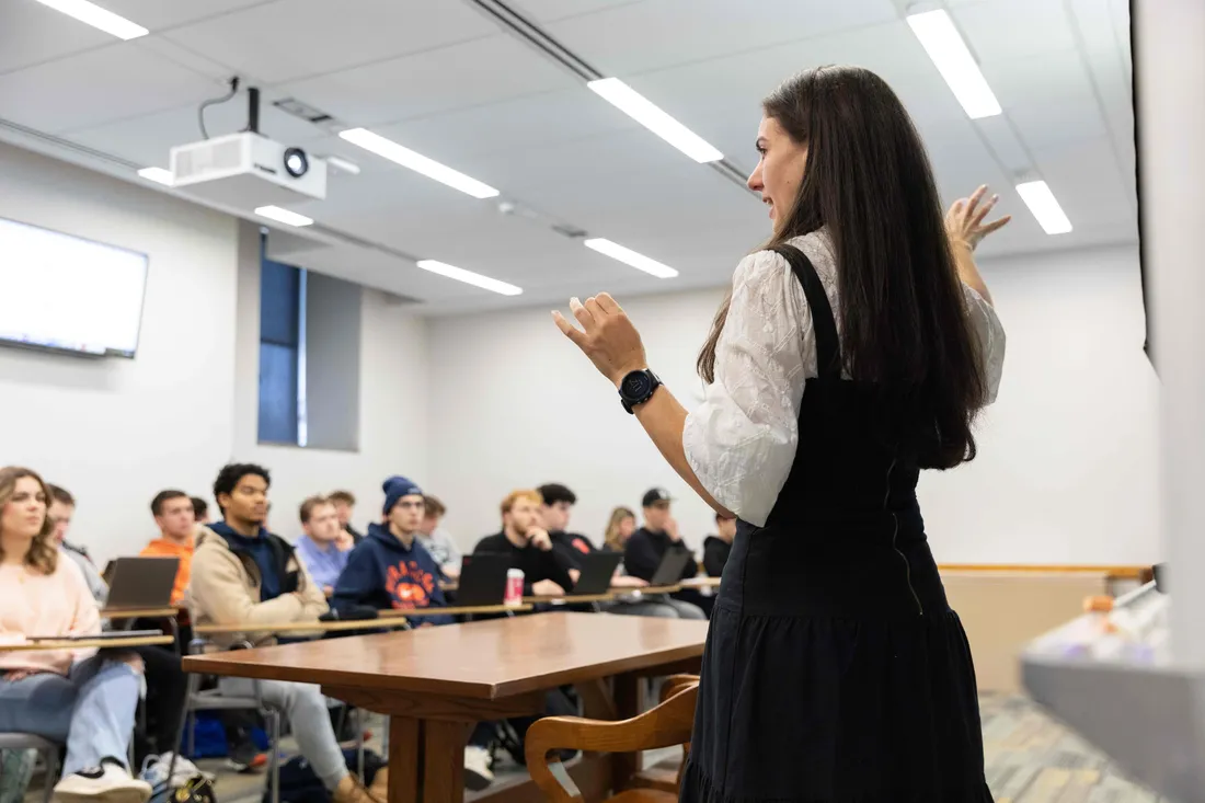A professor teaching a classroom full of students.