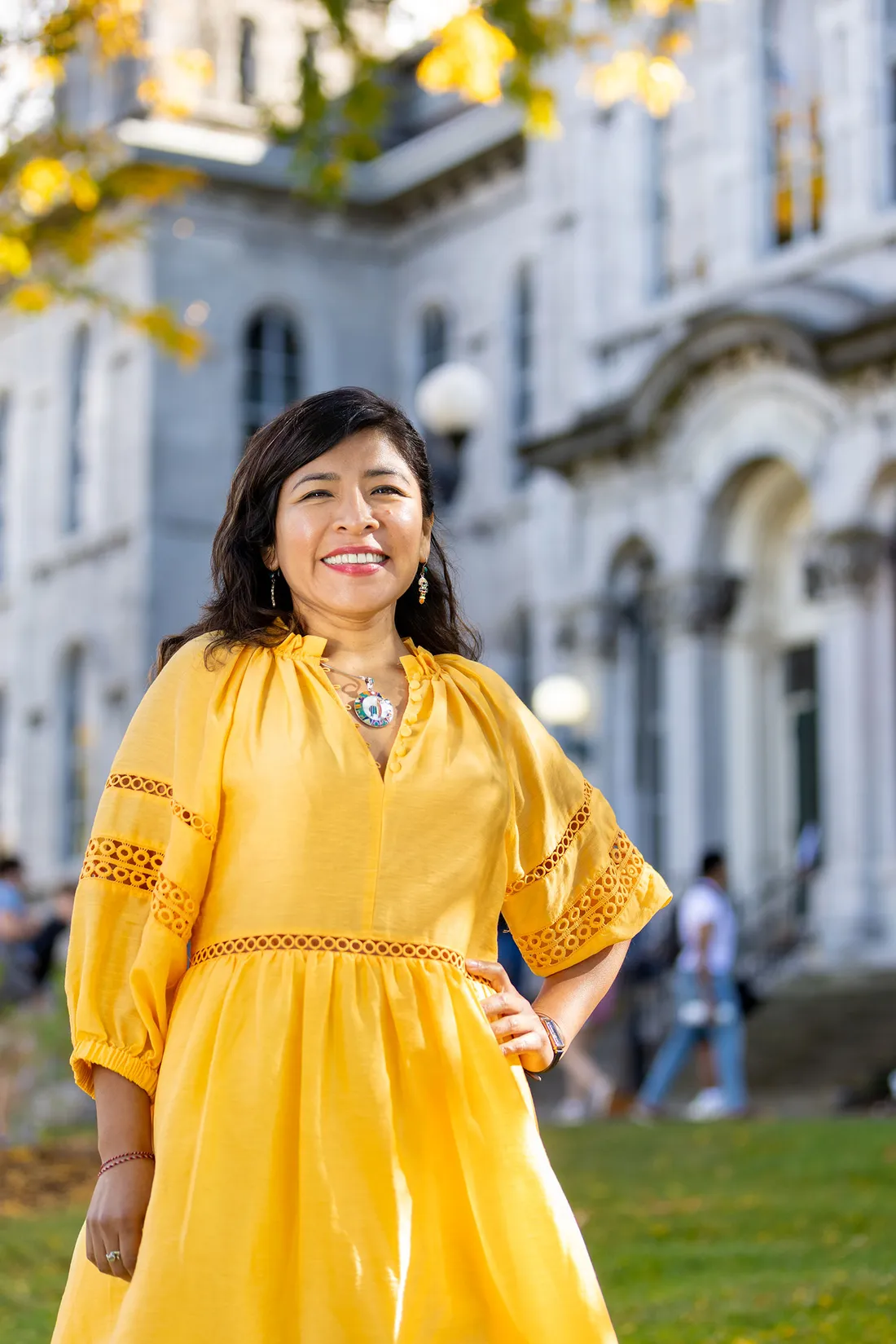 Person standing in front of campus building posing for picture.
