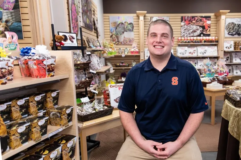 Portrait of Ryan Novak inside the Chocolate Pizza Company store