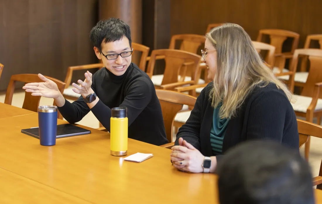 International student Kazumichi Nakagomi speaking with his English conversation group facilitator.