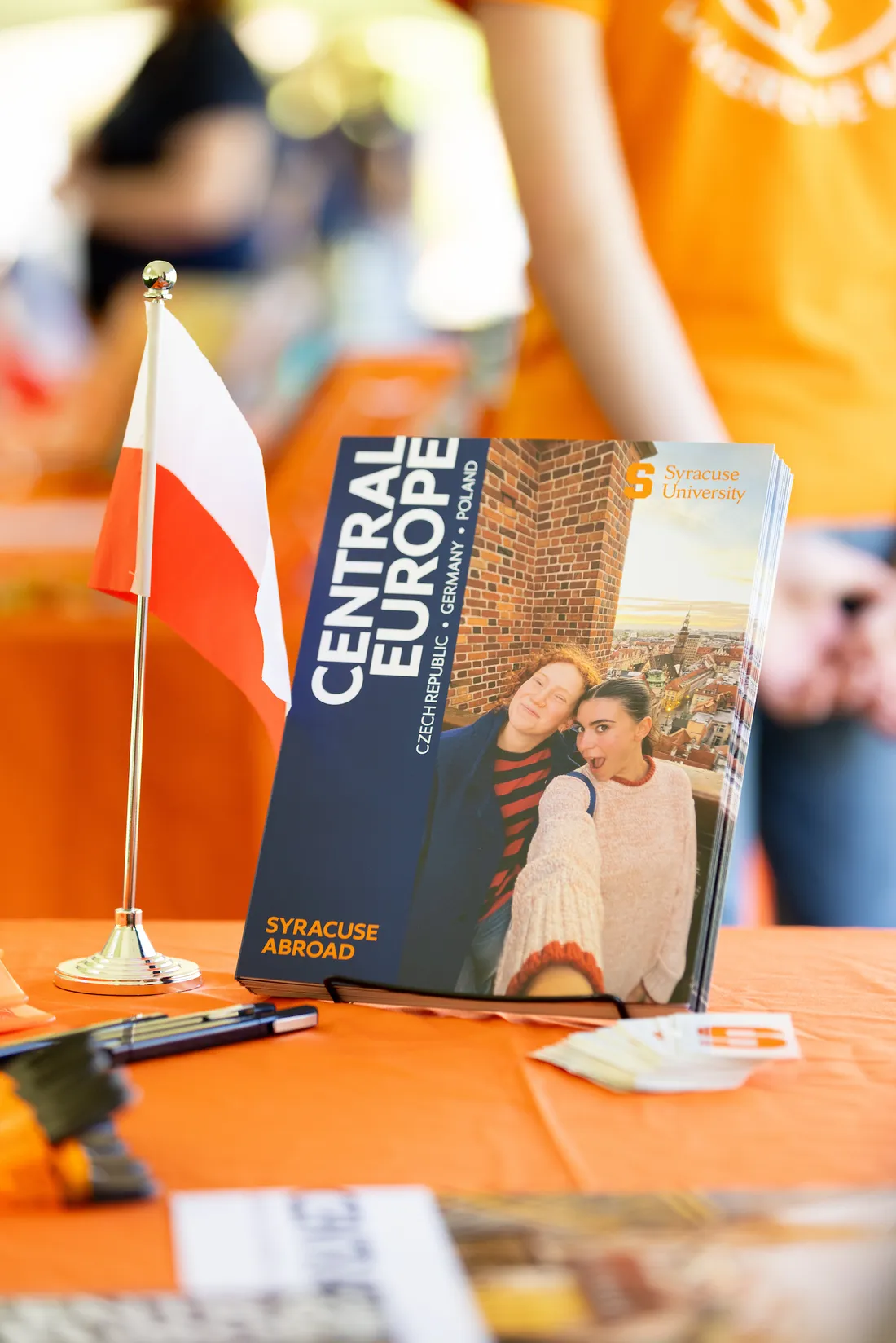 A brochure featuring central europe locations on a table at an abroad fair.