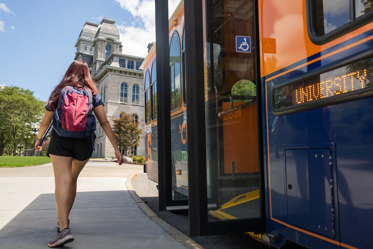 Student getting off bus outside of the Hall of Languages building.