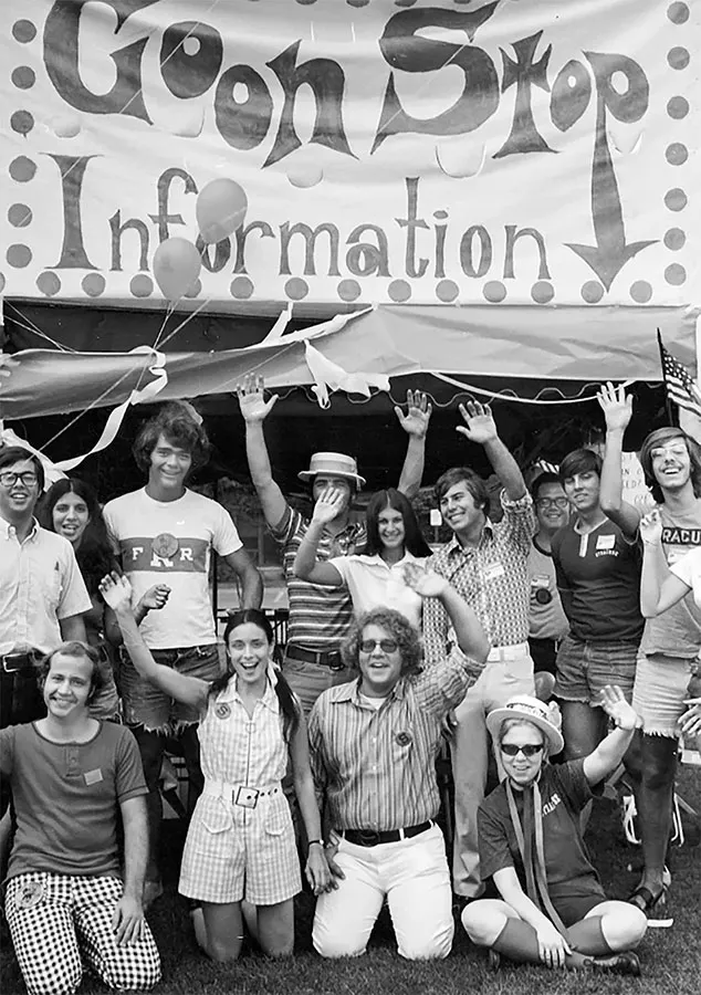Archived goon squad in front of sign.