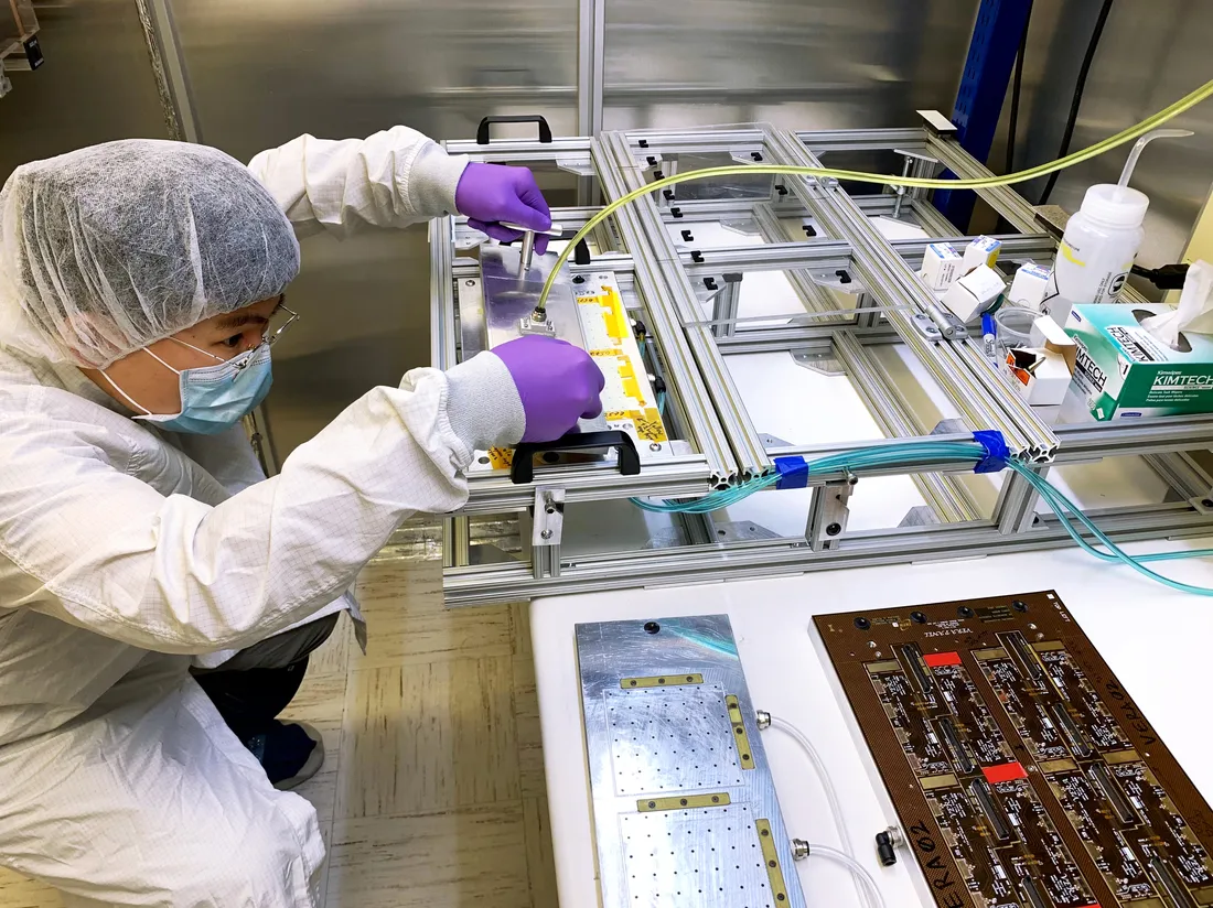 Postdoctoral researcher Hangyi Wu working on machine in laboratory.