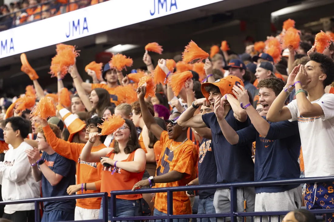Crowd of fans cheering at a game in the dome.