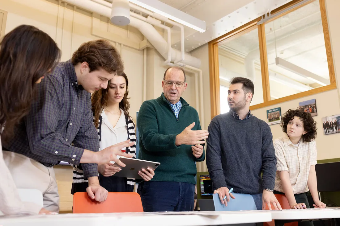 Professor Jay Golden speaking with students.