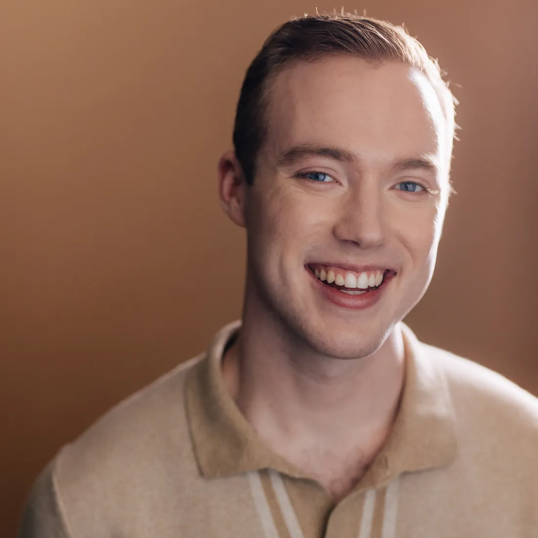 Actor smiling at camera in a headshot