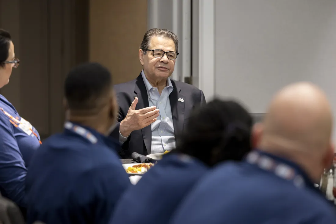 Dan D'Aniello speaking to a group of people at an event.