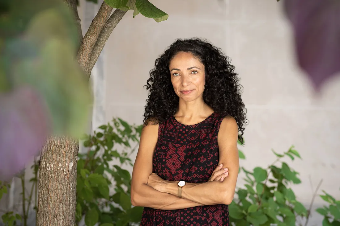 Portrait of Chanelle Benz, smiling with her arms crossed.