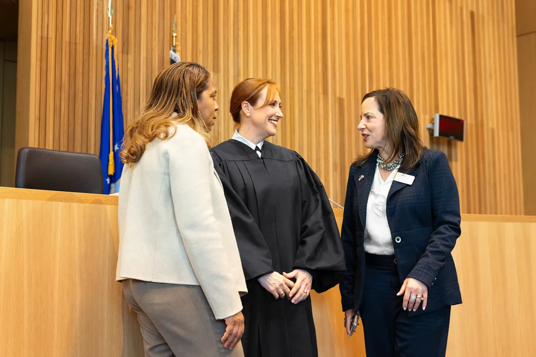Syracuse University alumni speaking with a College of Law Professor following an U.S. Air Force court hearing.